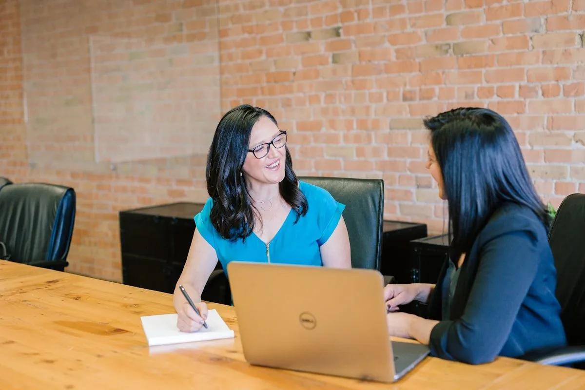 Two professionals working together at a laptop