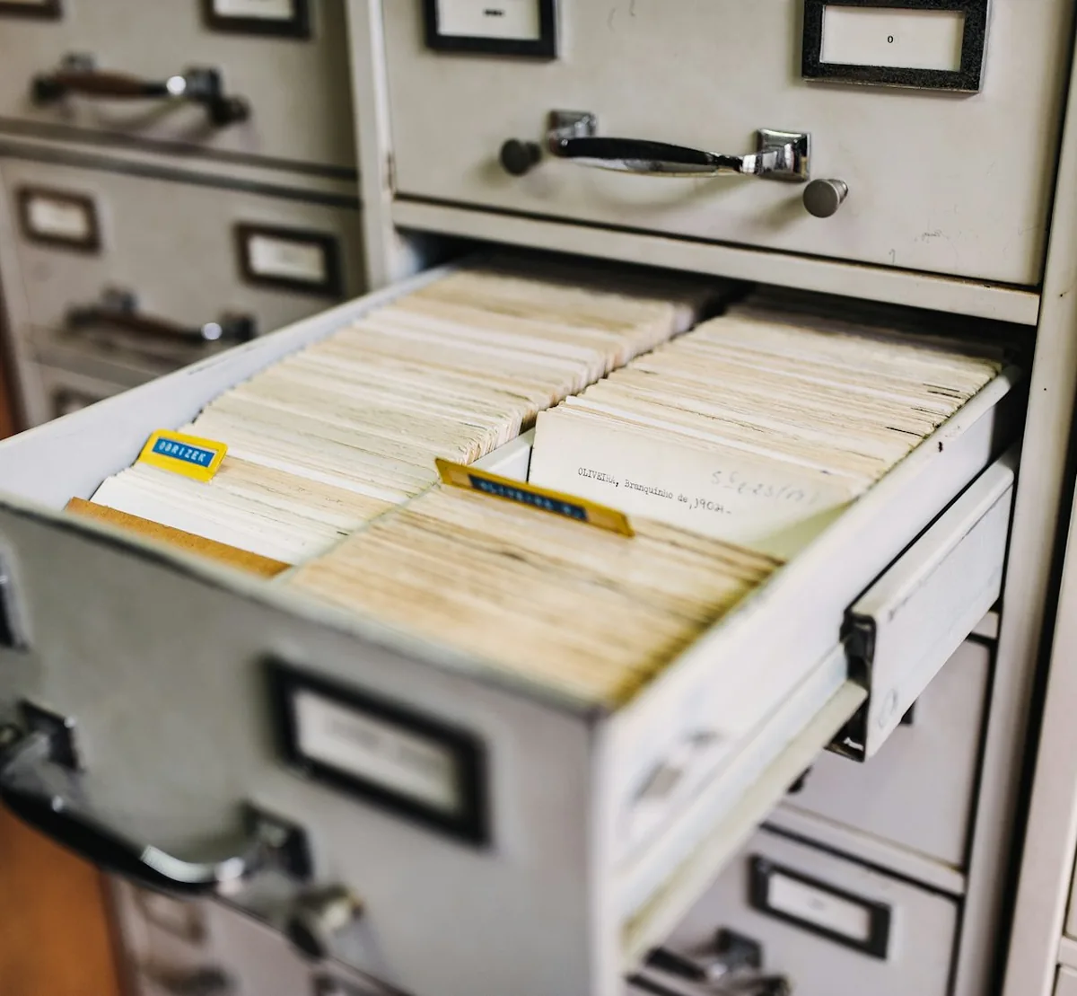 An open drawer of a card index filing cabinet